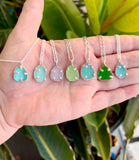 a variety of sea glass prong necklaces